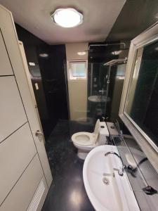 a bathroom with a white toilet and a sink at Lucky Suite Kandi 2 bedrooms in Angeles