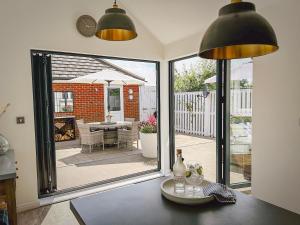 a kitchen with a large glass door with a patio at The Light House in Camber