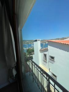 a room with a balcony with a view of the ocean at Hanedan Hotel Foca Izmir in Foca