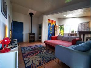 a living room with a couch and a rug at Ti Coin La Paix Airbn'beer in Étang-Salé