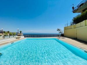 a swimming pool with the ocean in the background at Elisa's House in Taormina