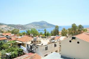 a view of a town with buildings and the ocean at Kelebek Apartments in Kalkan