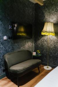 a living room with a couch and a lamp at In de Brouwerij in Leeuwarden +42 photos