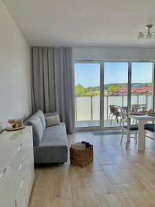 a living room with a couch and a table at REMAR - Apartments Lake Biale in Augustów