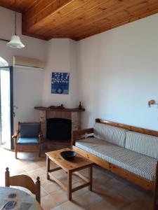 a living room with a couch and a table at Skardamoula's Studios and Apartments, 2 in Kardamyli