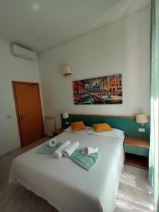 Postel nebo postele na pokoji v ubytování Hotel Castelfidardo