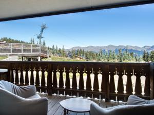 a balcony with chairs and a view of the mountains at Appartement Courchevel 1850, 4 pièces, 6 personnes - FR-1-564-30 in Courchevel