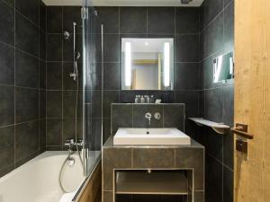 a bathroom with a sink and a shower and a tub at Appartement Courchevel 1850, 4 pièces, 6 personnes - FR-1-564-42 in Courchevel