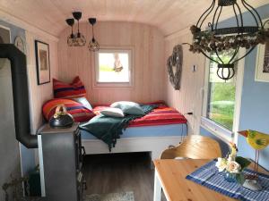 a small bedroom with a bed and a window at Auszeithof in Niederfrohna