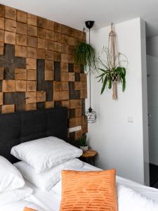 a bedroom with a bed and a wall mounted wall clock at Wolf Hotel Kitchen & Bar in Alkmaar