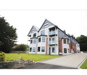 a large white building with a lot of windows at Impressive newly built apartment in Conwy