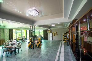 a restaurant with tables and chairs and people sitting at tables at Delta Hotel in Ureki