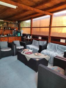 a restaurant with couches and tables in a room at Casuta De La Mare Corbu in Corbu