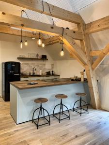 a kitchen with a large island with two bar stools at NJOLA in Sohland am Rotstein