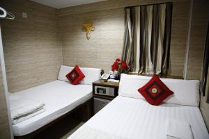 Ένα ή περισσότερα κρεβάτια σε δωμάτιο στο Legend Guest House