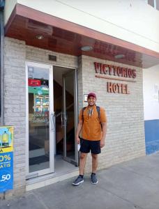 a man is standing in front of a hotel at Victtorios Hotel in Satipo