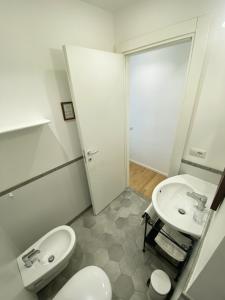 a bathroom with a toilet and a sink at Alloggio ad uso turistico - The Apartment n.2 in Anguillara Sabazia +40 photos