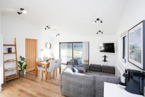 a living room with a couch and a table at Castlehill cabin with a hot tub in Peebles