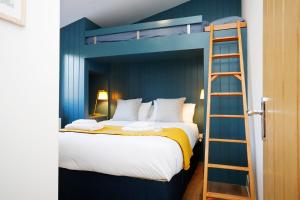 a bedroom with a bunk bed with a ladder at Castlehill cabin with a hot tub in Peebles