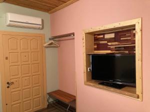 Televízia a/alebo spoločenská miestnosť v ubytovaní Catalina's house -Μικρή εξοχική κατοικία με αυλή & parking