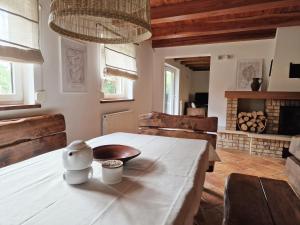 a dining room with a white table and a fireplace at Kamillo in Kołczewo