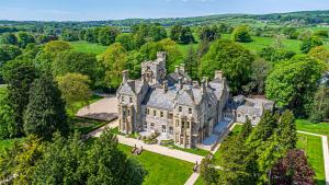 an aerial view of an old mansion with trees at The Theobold Suite Stone Cross Mansion in Ulverston