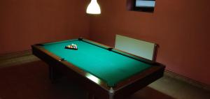 a pool table with balls on top of it at Pensiunea La Turcu in Moieciu de Sus