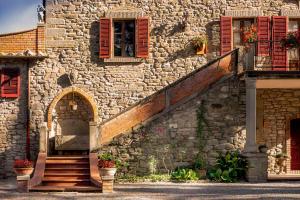 un edificio de piedra con escalera y ventana en Villa Giarradea, en Cortona
