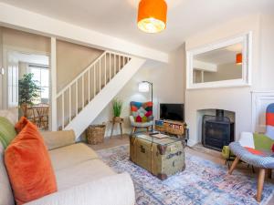 a living room with a couch and a fireplace at Pass the Keys Charming 2 bed cottage with parking in Canterbury in Canterbury