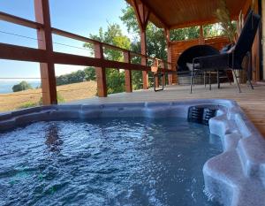 a hot tub in a house with a deck at Cabanes Trésors de Campagne,spas privatifs in Villarzel-du-Razès