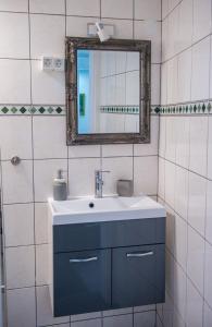 a bathroom with a blue sink and a mirror at Studio Gallery in Mostar +17 photos
