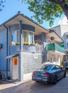 a car parked in front of a house at Studio Gallery in Mostar