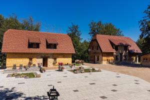 two large wooden buildings with trees in the background at Grand Lakes 2 in Plitvička Jezera
