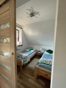 Posteľ alebo postele v izbe v ubytovaní Apartamenty Cichy Kącik