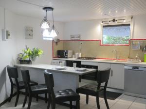 a kitchen with a counter with chairs around it at Serenity in Gros-Morne