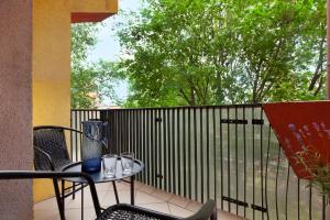 a table and chairs on a balcony with a fence at Elite Apartments Center Deluxe in Gdańsk