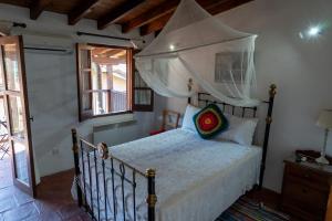 a bedroom with a bed with a canopy at Zangoulos Villa in Kakopetria