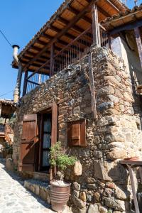 a stone building with a potted plant in front of it at Zangoulos Villa in Kakopetria