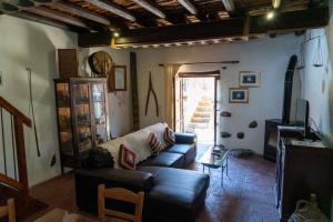 a living room with a couch and a tv at Zangoulos Villa in Kakopetria