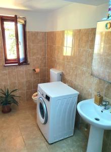 a bathroom with a washing machine and a sink at Casa Nautica in Jurilovca +21 photos