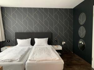 a bedroom with two beds and two night stands at MOTELO Bielefeld - Smart HOTEL in Bielefeld