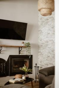 a living room with a couch and a fireplace at El Retiro de la Adrada AVILA in La Adrada