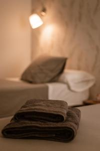 a stack of towels sitting on top of a bed at El Retiro de la Adrada AVILA in La Adrada