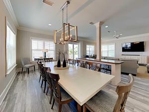 a dining room and living room with a table and chairs at Beach Music in Gulf Shores