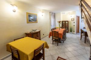a living room with two tables and a yellow table cloth at B&B Il Vicoletto Del Casale in Centola