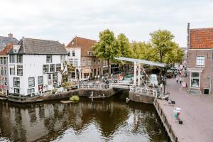 a bridge over a river in a city with buildings at Wolf Hotel Kitchen & Bar in Alkmaar