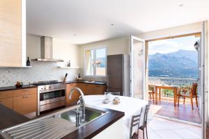 a kitchen with a view of a mountain at U PIAZZALE in Santa-Reparata-di-Balagna