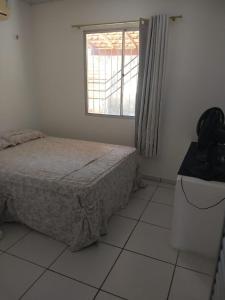 Ένα ή περισσότερα κρεβάτια σε δωμάτιο στο Sua casa no litoral