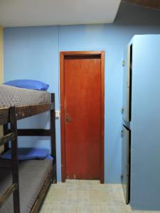 a room with two bunk beds and a door at Hostel Park Iguazu in Puerto Iguazú