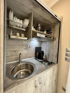 a kitchen with a sink in a small room at ATLANTIS APARTMENTS in Artemida +38 photos